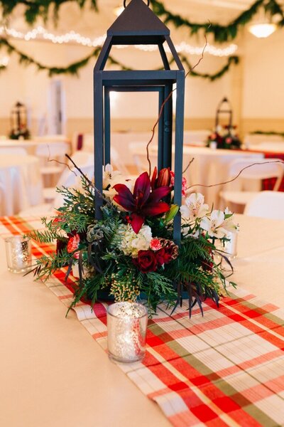 Floral arrangement for a Christmas themed wedding representing an example of service available in the wedding florist packages.