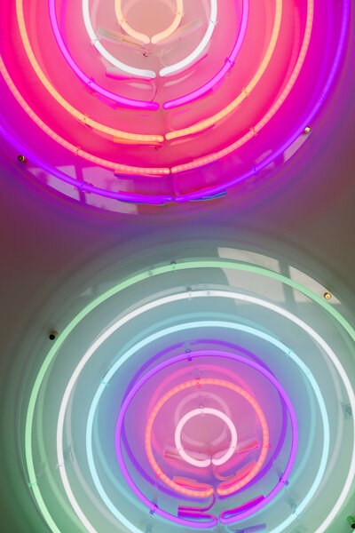 Glowing neon circle wall art during a branding session in Greenville SC by Dani Lacey Photographs.
