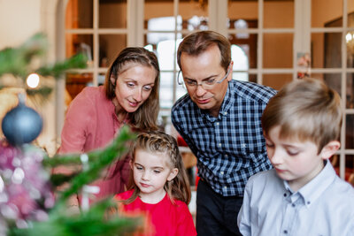 A family looking at the Christmas tree