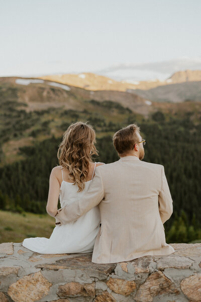 Couple watching the sunrise at Loveland Pass during their Colorado elopement.
