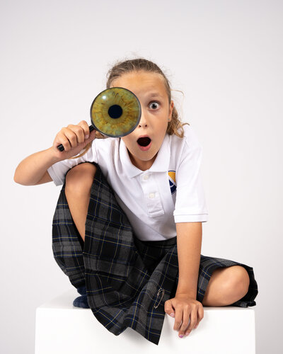 School girl with macro photo of iris