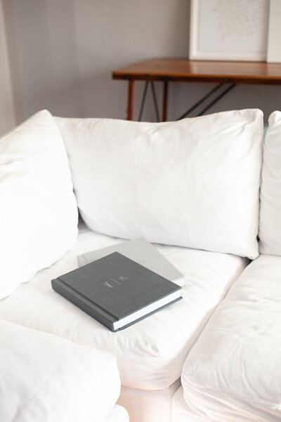 Wedding photography albums laying on couch
