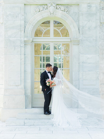 bride-groom-kissing-at-elms-mansion-in-newport-jamalandlashanaphotography