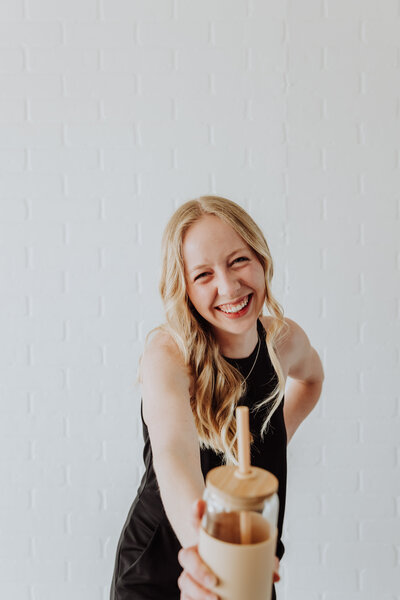 hannah drinking coffee while coordinating a wedding