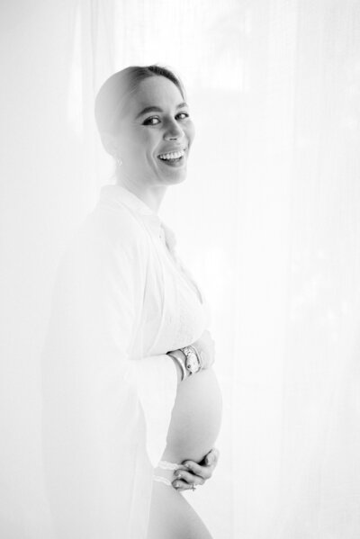 Pregnant woman laughing at camera by Miami Maternity Photographer