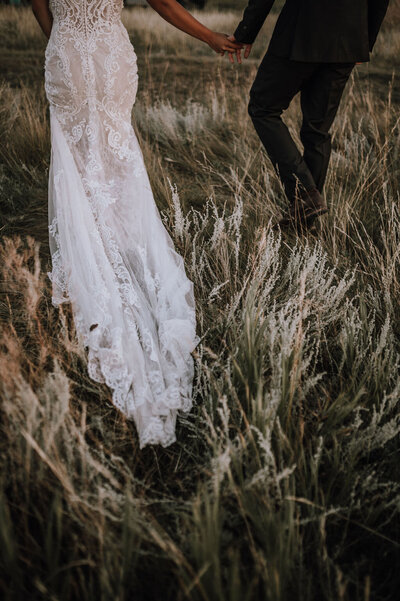 back of lace wedding dress on a green field