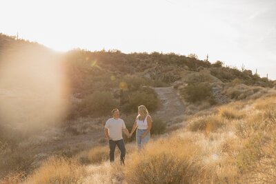 couple hold hands in arizona desert