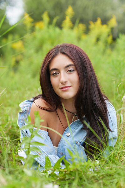 Senior girl laying in grass