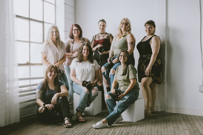 a group of 8 female photographers pose together for a group shot after an educational event photography mentorship photography classes hagerstown maryland frederick maryland chambersburg pennsylvania