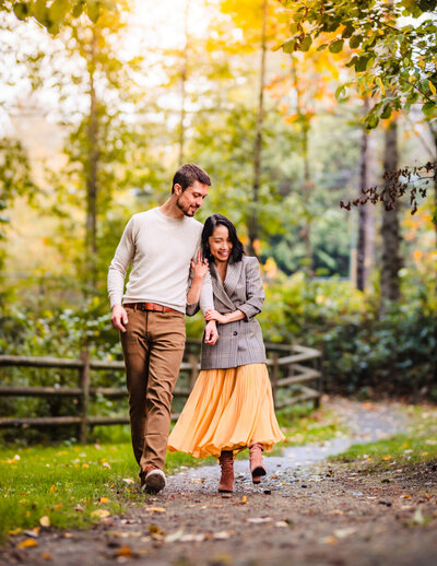 A young couple linking arms during a couples portrait session in Redmond, Washington, on Seattle's Eastside.