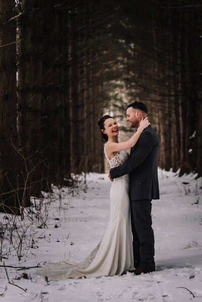 Wedding Portrait in pines and snow for just married couple.