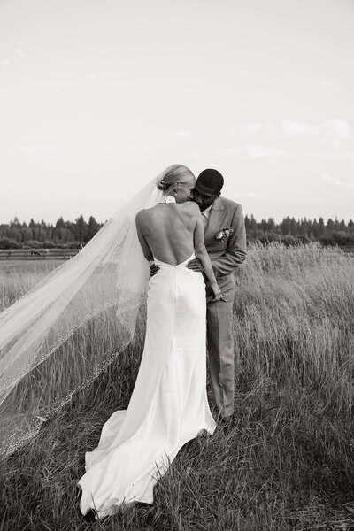 bride and groom holding hands while their bridal party is standing around them