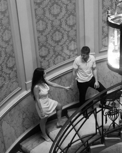 Engagement Shoot, he is holding her hand and leading her in the stairs