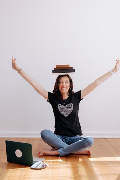 Carrie balancing a stack of books on her head