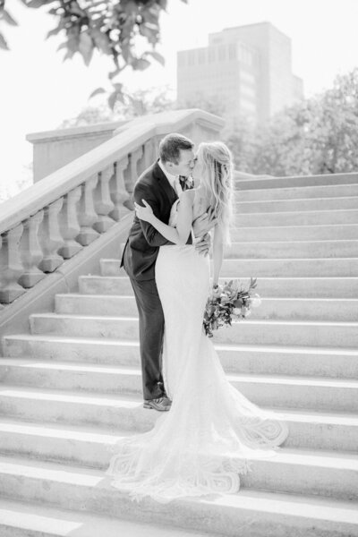 Bride and groom kissing on stairs in downtown nebraska