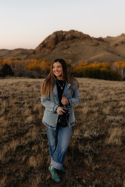 Self-portrait of a Wyoming-based wedding and lifestyle photographer, capturing a professional and artistic shot
