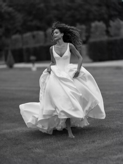 A bride running in a ballgown.