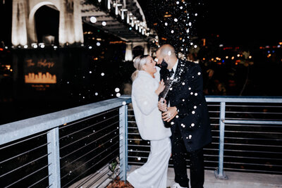 Destination Wedding Photographer captures bride and groom popping champagne