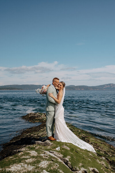 Elopement wedding photo of a couple on a remote British Columbia shoreline