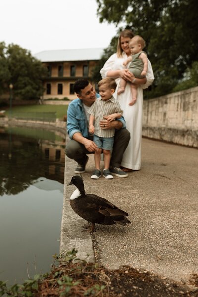San Antonio family posing by a pond