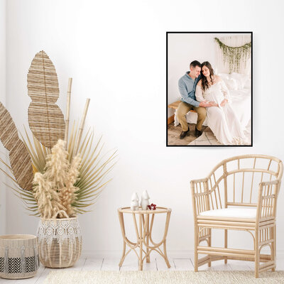 framed maternity family photo of couple sitting on a bench in Joplin