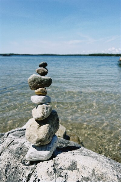rock stacking up on the huge rock lake is in the background