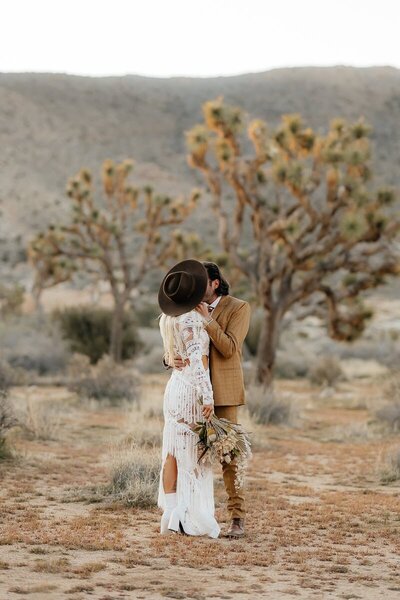 Sleeveless wedding dress hung up at Alta Lodge Wedding with mountains in behind