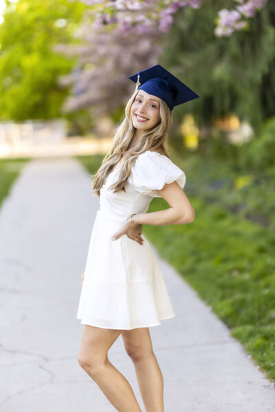 Photo of a blond girl with a Gonzaga flag, jeans and top by a Gonzaga graduation Photographer in Spokane 