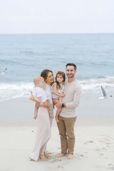Family photoshoot at Windansea Beach with the beach and seagulls in the background.