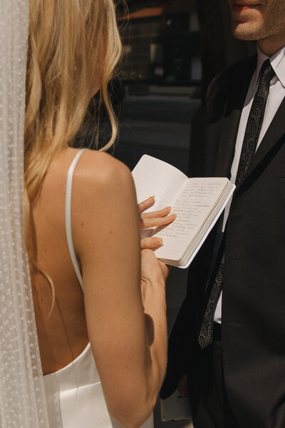 bride and groom embracing on beach
