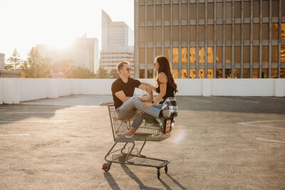parking garage engagement photos in a shopping cart
