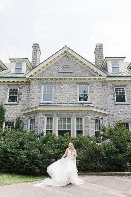 Portrait of the bride in her pretty princess gown in front of Stewart Hall in Pointe Claire.