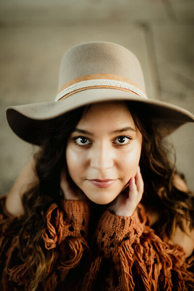 close up of girl in a  hat during senior photo session