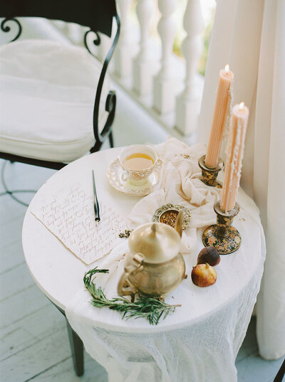 Organic wedidng breakfast table on the patio of 86 Cannon with blush candles, gauzy cheesecloth and hot tea