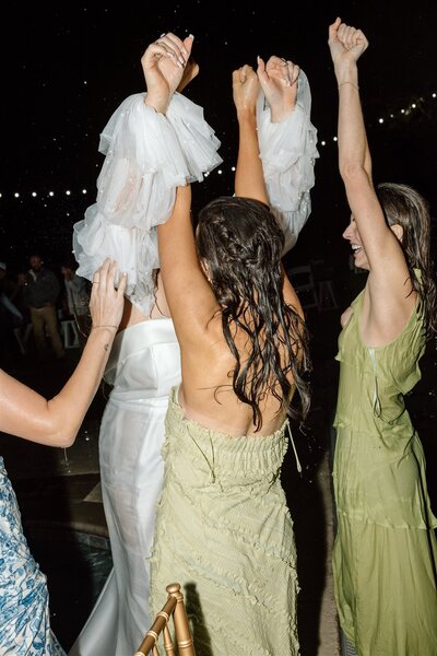 Modern Wedding at The Orchard  in Wedding Attire walking in field.