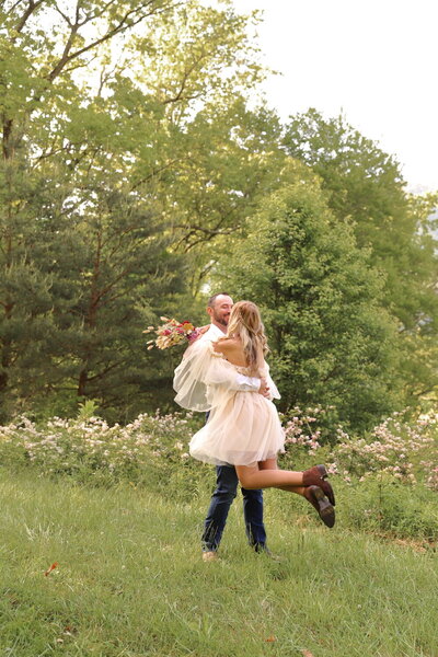 Couple twirling around in celebration during their elopement in Asheville North Carolina
