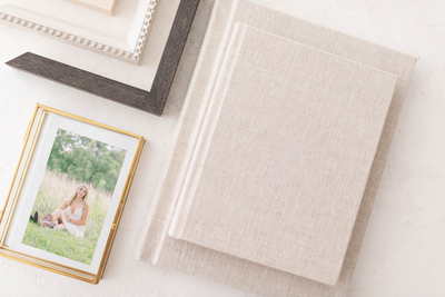 A glass keepsake box filled with fine art photo prints of a senior girl by Raleigh senior photographer, Lindsey Lambert Photography.