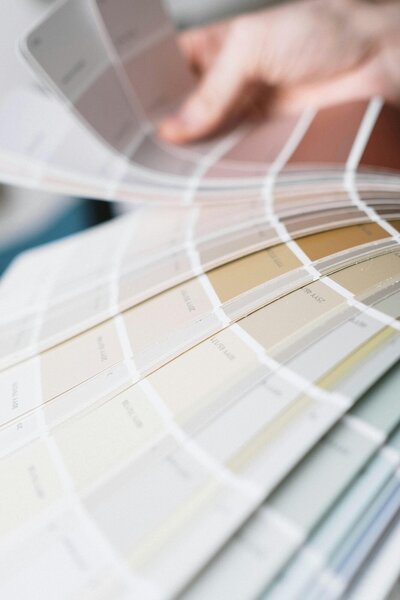 Hand flipping through a pamphlet of color swatches