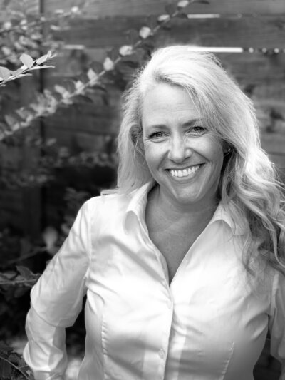 smiling blonde-haired woman wearing a white shirt