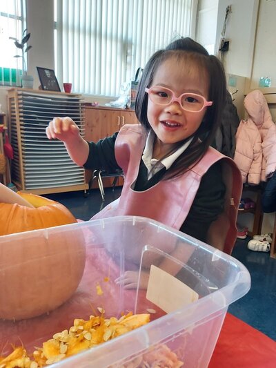 Student carving a pumpkin at Cloverdale Montessori