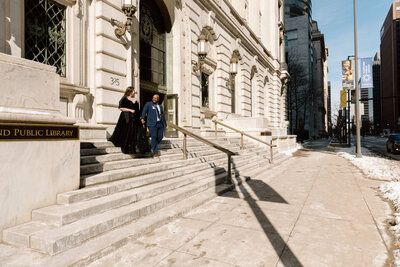 Bride and groom walking down the steps of the Cleveland Public Library