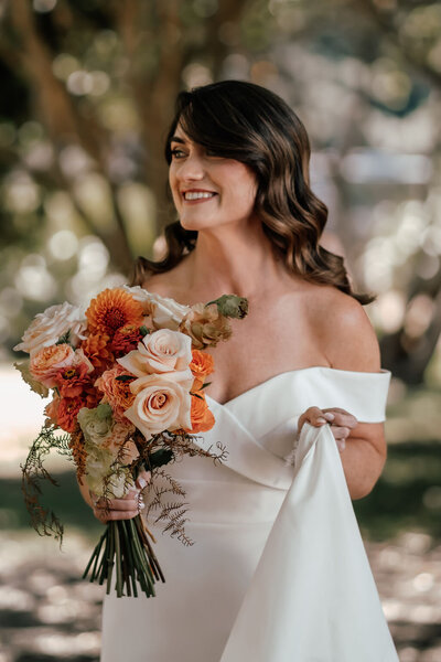 Bride Lorna holding bouquet of pastel flowers during Waiheke Island wedding, photographed by Auckland wedding photographer Zanthe Vorsatz.