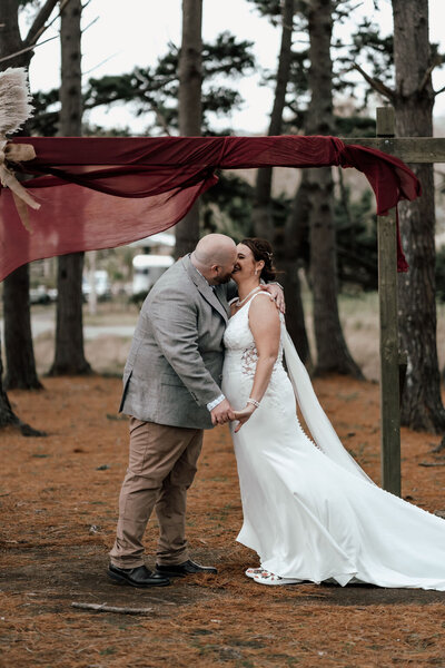 Newlyweds Nardus and Dehlia walking together after their Auckland wedding ceremony, captured by Zanthe Vorsatz.