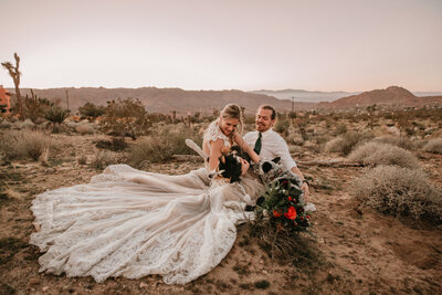 bride and groom kissing in the desert