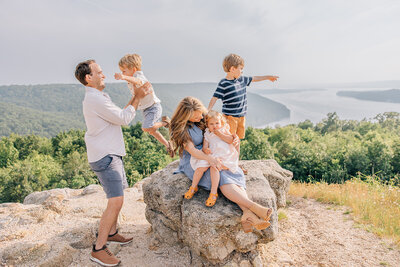 Family Photography in Madison Alabama by Whitney Briscoe mom and dad with 3 small children on top of mountain