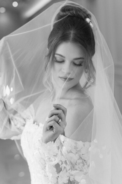 a bride posing in her wedding dress and veil