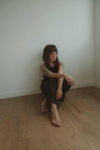 Mother with her two children during a family photo session in Costa Mesa, Orange County. They are posed beneath desert trees with soft natural light, blending candid lifestyle moments with relaxed family portraits.