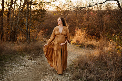 Expecting mom showcasing a beautiful dress from Paula Gofroth's client closet while enjoy a pleasant day in a park in Lake Worth, Texas