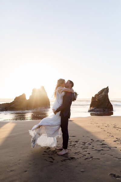 Newlyweds kissing on the beach in Bandon, Oregon