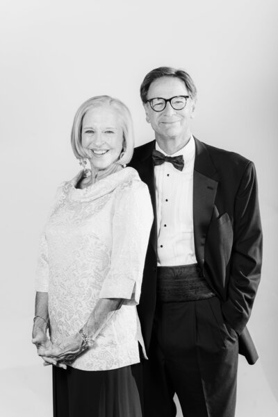 Black and white portrait of a smiling couple in elegant formal wear taken at a Vogue Portrait photo booth in Richmond, VA.